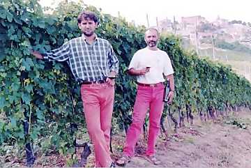 Enzo and Gianni Boglietti brothers in
their vineyard. In the back the city of La Morra